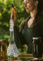 Aureterra founder holding the Glow Starter Kit products in natural golden light, showcasing sun-infused botanical skincare. Clinically proven, dermatologist tested clean beauty skincare.